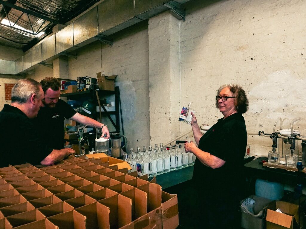 Julianne and our staff members bottling the gin. 